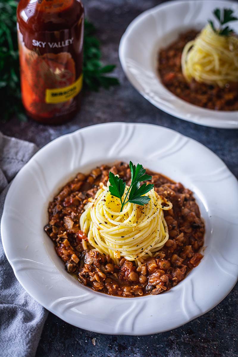 Bowls of Spicy Lentil Bolognese with Sky Valley Sriracha